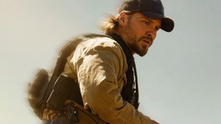 Luke Grimes looks at something off-screen